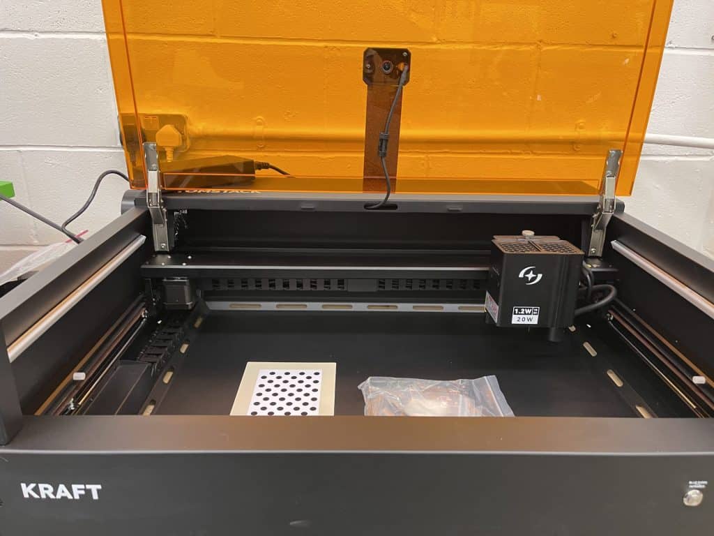 Precise laser engraver with orange safety shield, ideal for DIY maker projects and 3D printing enthusiasts.