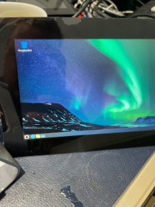Rugged Raspberry Pi touchscreen with Aurora Borealis wallpaper, perfect for maker projects.