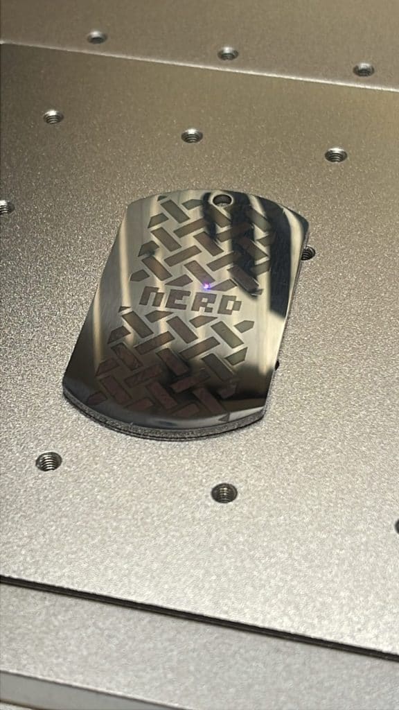 Metal robot foot with intricate geometric pattern, on a metallic surface.