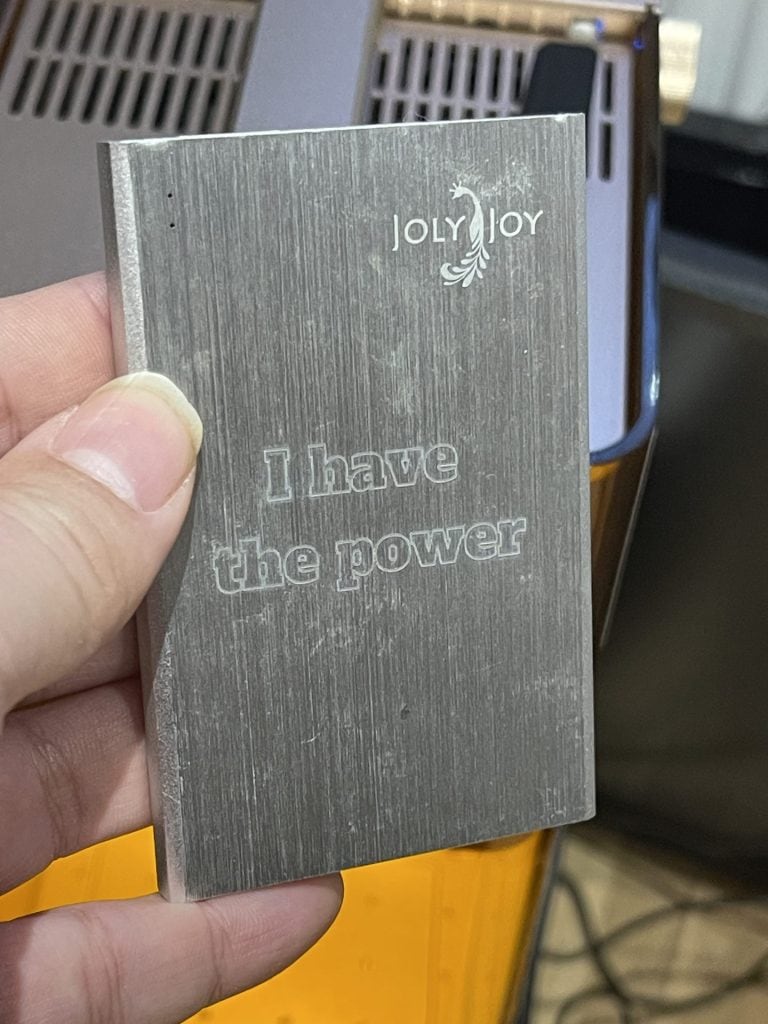 Metal engraved business card with motivational quote, "I have the power", showcasing DIY metalworking art skills.