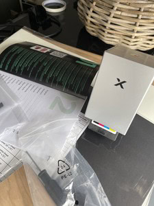 XTool M2 laser engraver and print device on a desk with accessories.