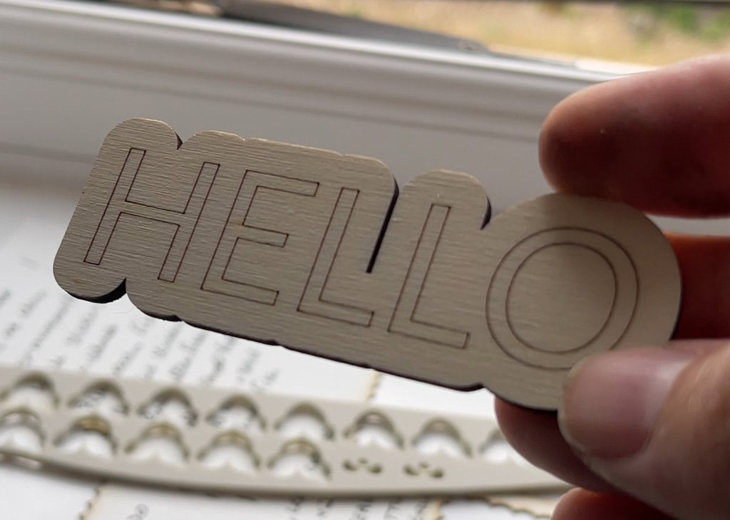Close-up of a laser-engraved 3mm poplar 'HELLO' sign 