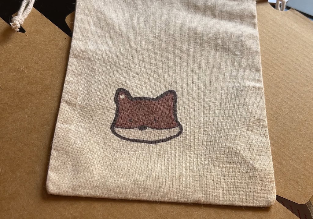 Beige fabric bag with a printed fox face design